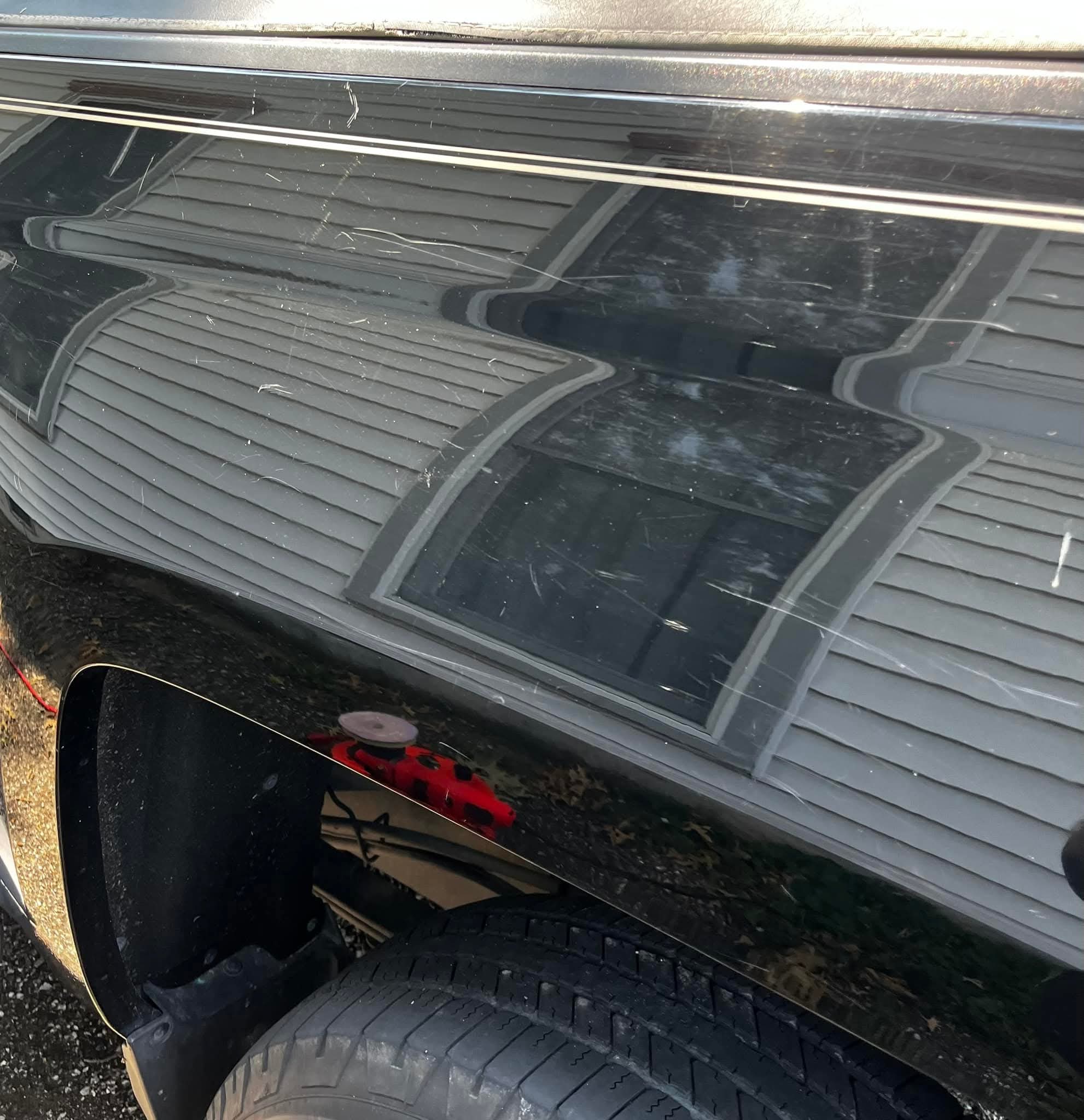 Black paint before correction — heavy swirls and surface scratches
