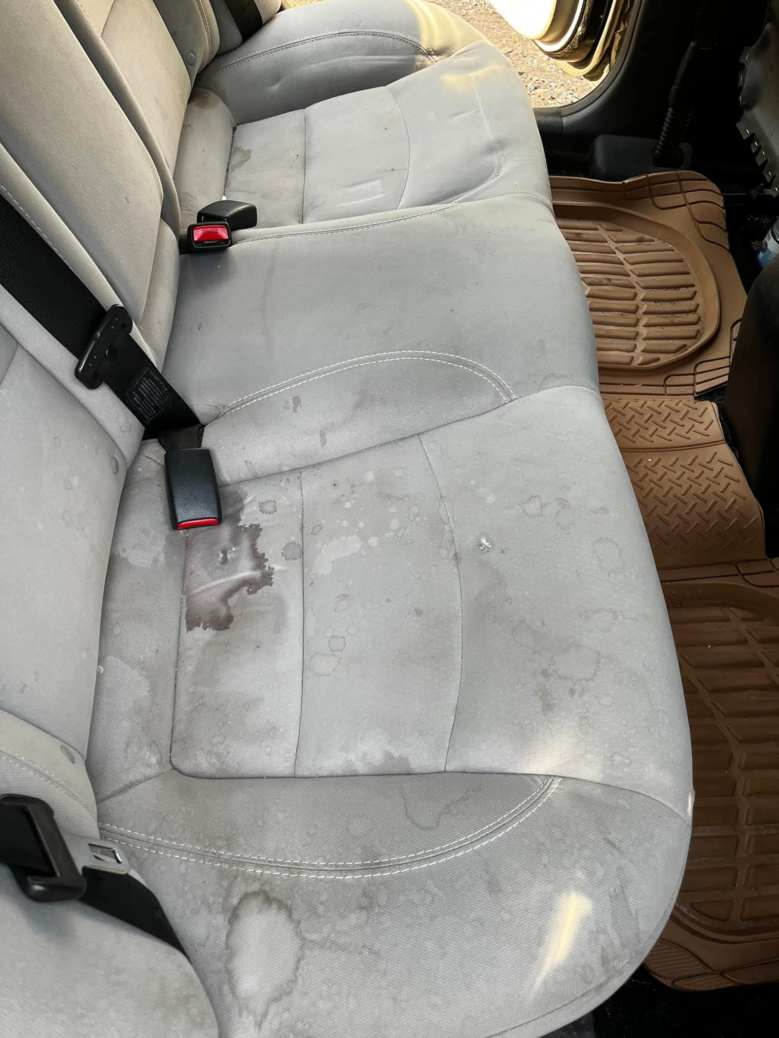 Heavily stained cloth rear seats before interior reset